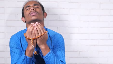 muslim man praying during ramadan, close up
