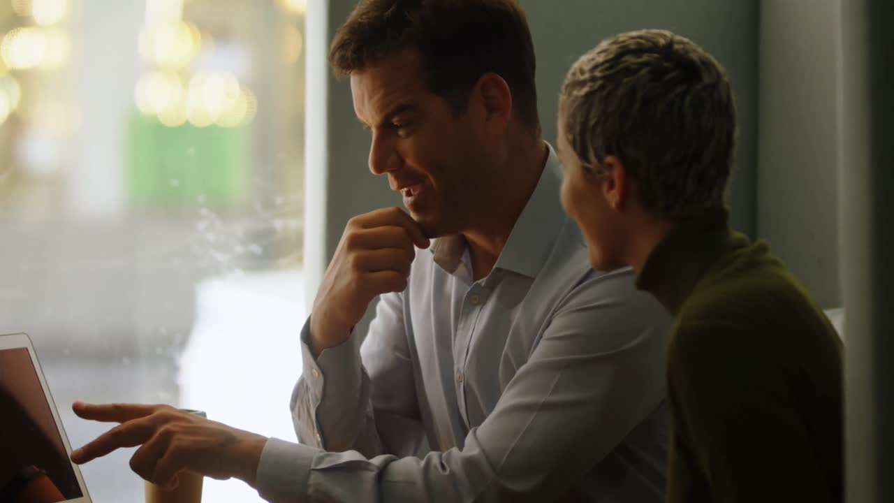 사무실 카페테리아 4k에서 노트북을 통해 논의하는 임원들