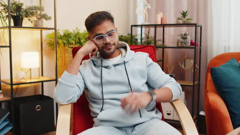 indian man at home suffers from unfair situation problem break up depressed feeling bad burnout