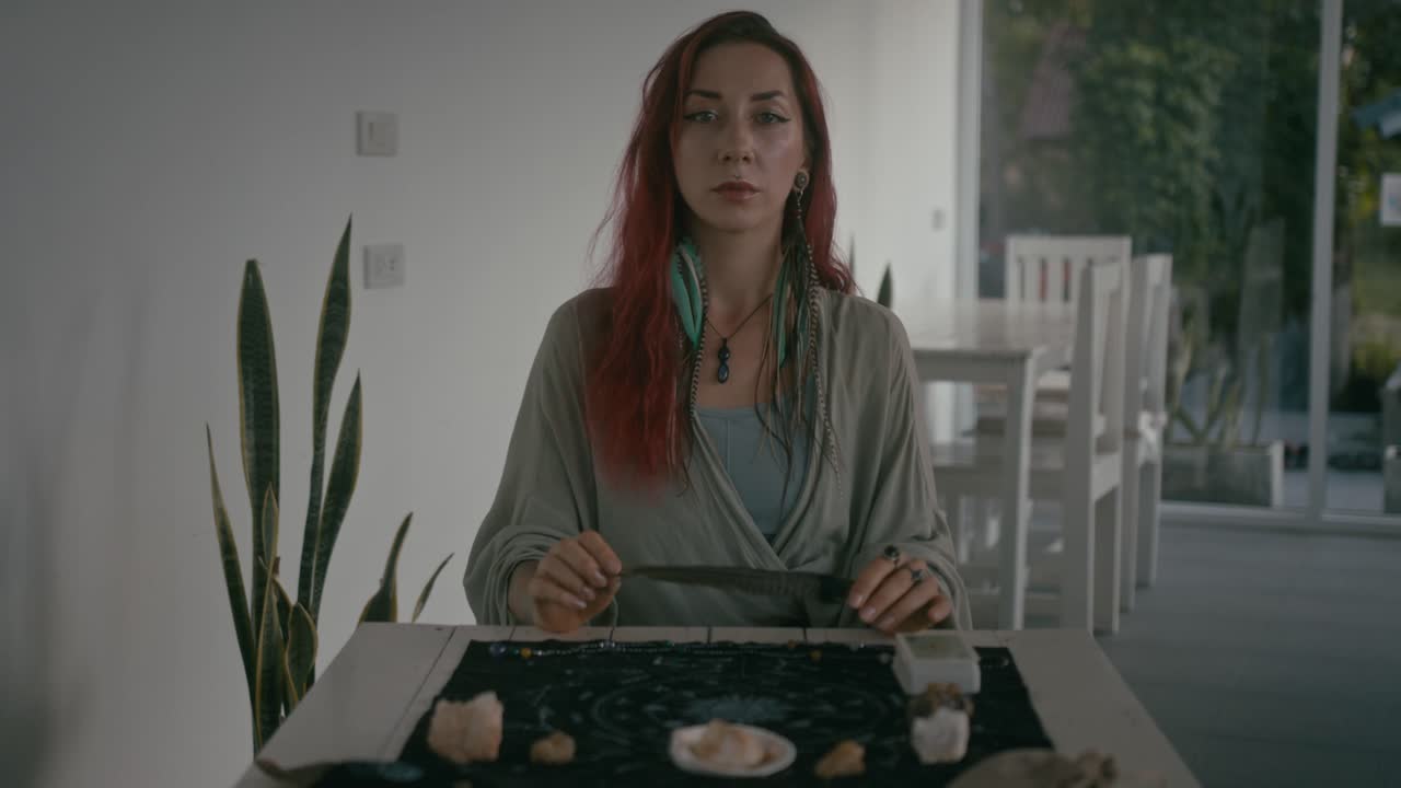 Woman performing divination with crystals and tarot cards