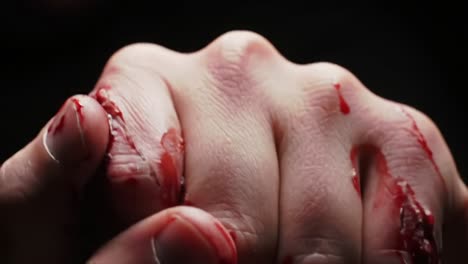 A Close-Up Perspective of a Bloodied Hand Clenching Into a Fist, Symbolizing Struggle, Pain, and Resilience Against Adversity in a Dramatic Context
