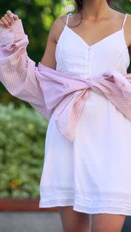 young woman in white dress and pink shirt