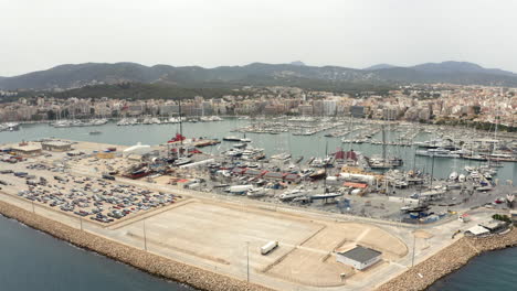 palma city port with parking lot platform and anchored boats in marina