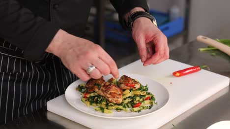 chef preparing a delicious chicken and pasta dish