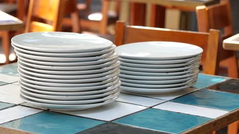 stacked plates on a restaurant table