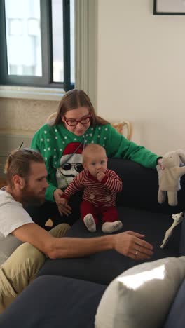 family with baby enjoying christmas at home