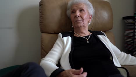 Closeup-of-pretty,-elderly-woman-talking-to-someone-and-describing-something-with-her-hands