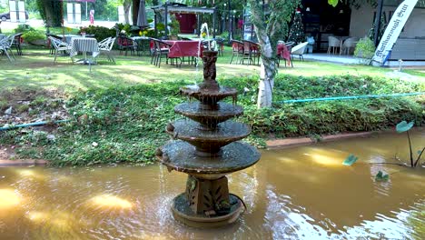 fountain amidst lush greenery and tranquil water
