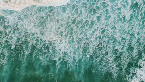 foaming ocean water splashing. aerial view beautiful waves rolling to seashore.