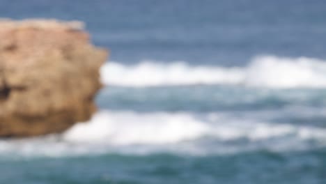 waves hitting a rock formation in melbourne