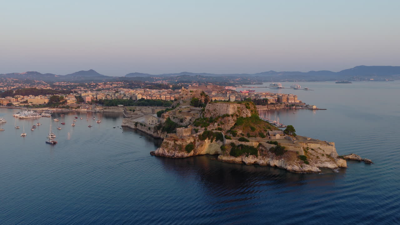 Aerial panoramic view of Corfu Old Town and marina with old fortress at sunrise, Greece