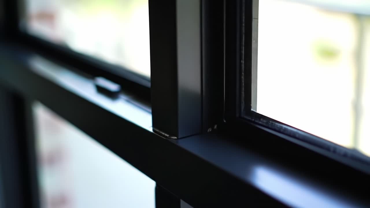 A Close-Up View of Window Frames Capturing Natural Light and the Subtle Details of Architectural Design in a Bright Environment