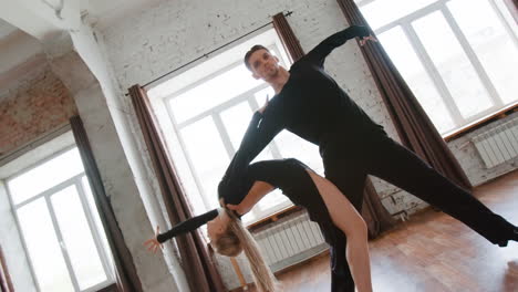 couple performing dynamic ballroom and latin dance in a studio