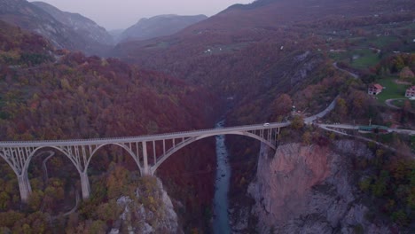 tara concrete arch bridge crossing steep canyon in montenegro, aerial