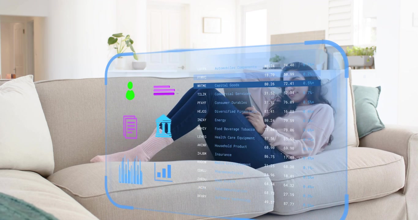 Mid adult woman reclining on sofa swiping tablet screen and analyzing finance data via panels