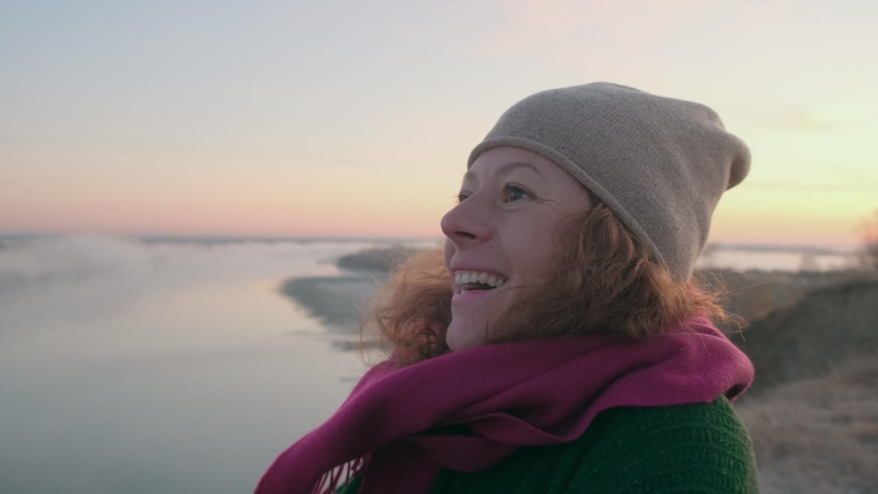 Woman enjoying a serene sunrise by the river