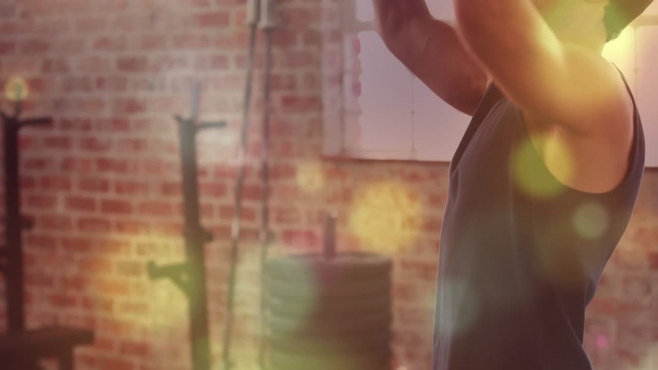 Man pressing barbell overhead in gym, starting reps from rack to train shoulders, bokeh over man