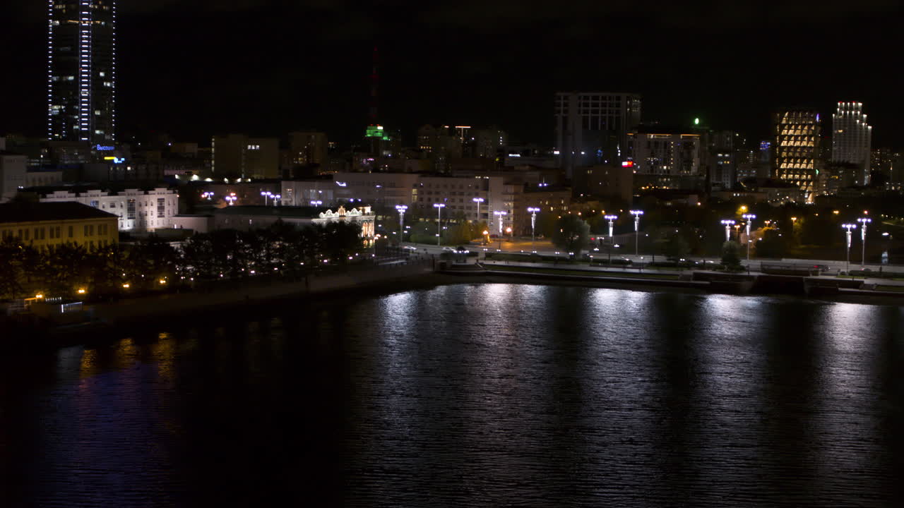 Cityscape at Night with River Reflection