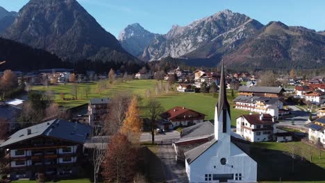 church and houses in austrian village pertisay by the lake of achensee in mountains