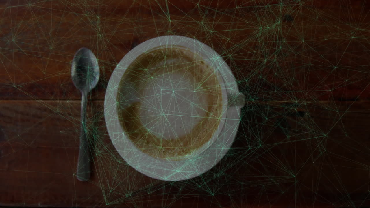 Network overlay being visualized over overhead coffee cup scene, with latte foam ring and spoon