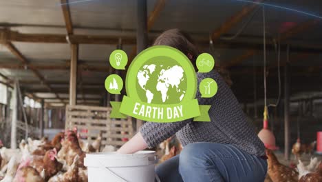 Animation-of-earth-day-text-banner-over-caucasian-woman-feeding-the-chickens-in-poultry-farm