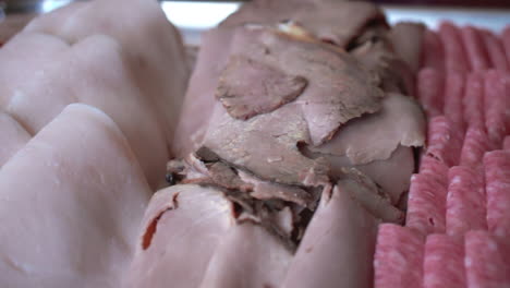 Variety-of-Folded-Lunch-Meats-on-Display,-Close-Up-Slider-Right