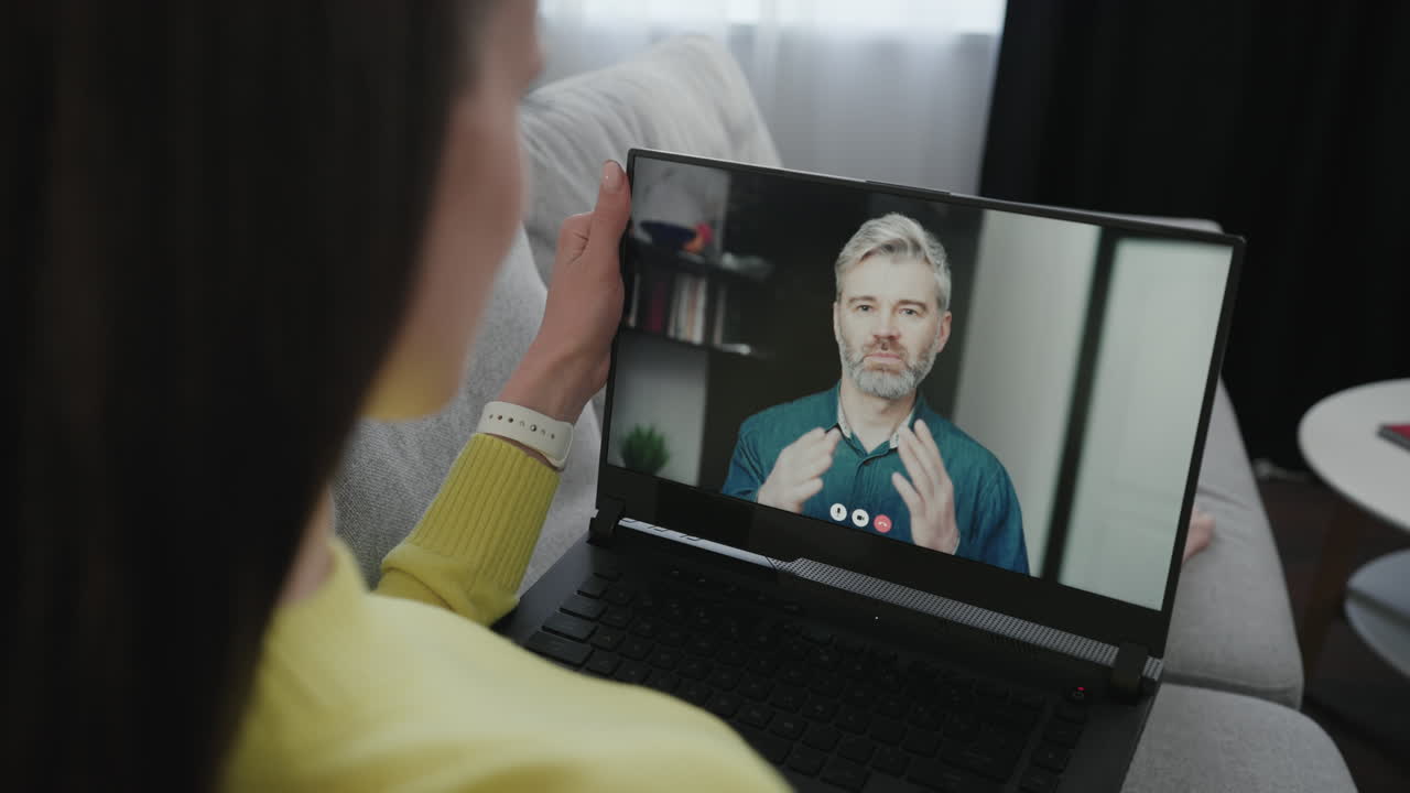 A woman is having a video call on her laptop