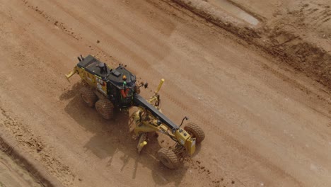 Grader-heavy-machinery-works-on-a-construction-site-drone-footage