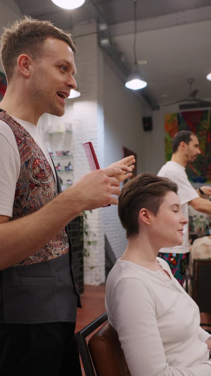 Kapper die een vrouw knipt in een kapsalon