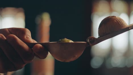 Close-up,-fruit-squeezer-and-placing-half-of-lime-in-utensil-making-citrus-juice