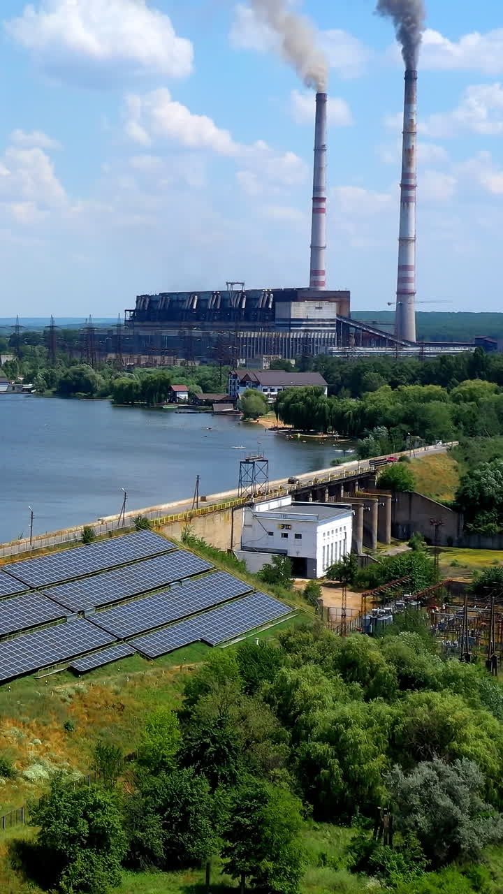 Motion camera view of the solar panels in the countryside. Flight over the innovation plant of creating ecological energy at daytime. Eco light from solar panels concept Vertical video