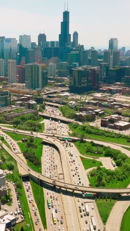 beautiful sight of a big busy city in america. multiple-lane roads crossing chicago city. sunny day picture of a city from top. vertical video