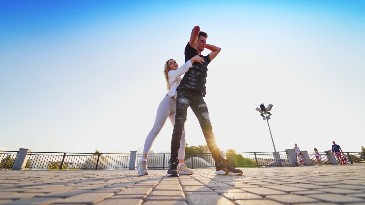 Happy couple dancing. Young people dancing in the rhythm of music in city