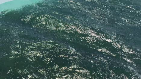 ariel shot of water rushing down a stream-rushing down niagara falls just before waterfall