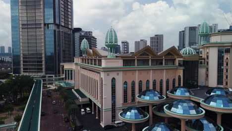 drone rising over the sunway city area toward the tower, in kuala lumpur, malaysia