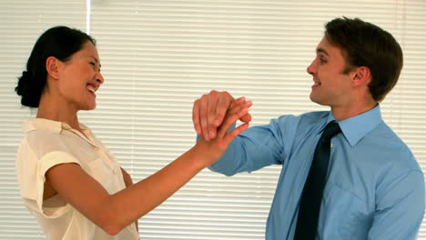 business people high fiving in the staff room