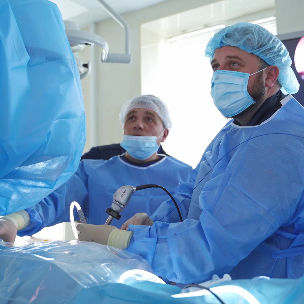 In surgery. Medical team performing operation in hospital operating theater. Working with surgical instruments