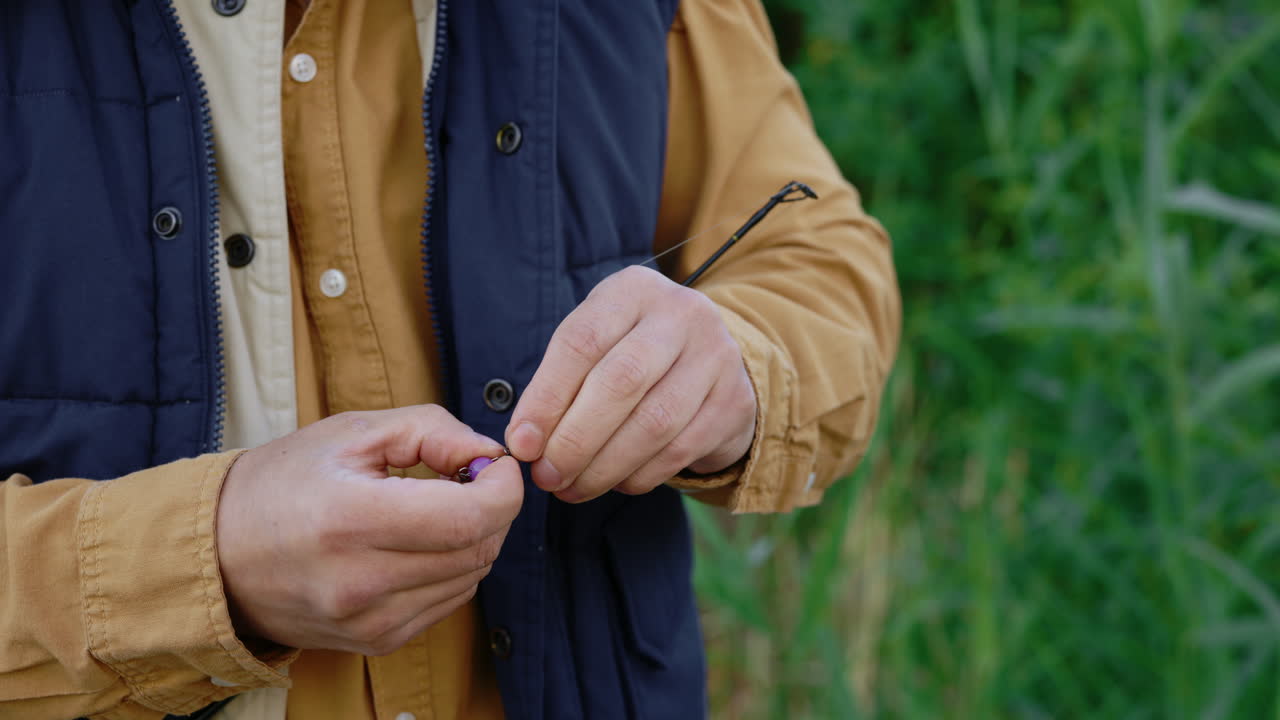 Man preparing fishing rod and bait