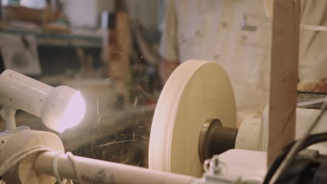 a man carpenter processes wooden blanks in a carpentry workshop