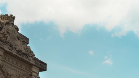 blue and cloudy sky of paris, france over a retro structured building