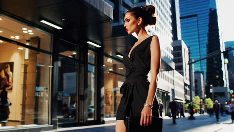 stylish woman in a black dress on a city street