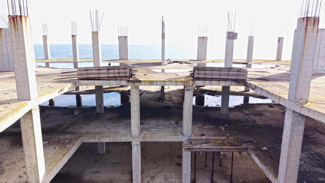 Construction site reveals the skeletal structure of a building under a bright blue sky, showcasing the raw beauty of progress and engineering at midday