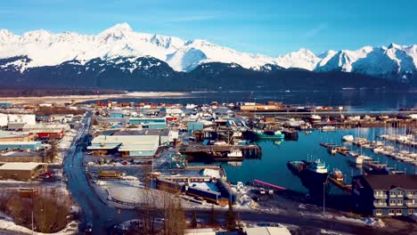 4K-Drone-Video-of-Seward-Boat-Harbor-and-Surrounding-Snow-Covered-Mountains-on-Snowy-Winter-Day-in-Alaska