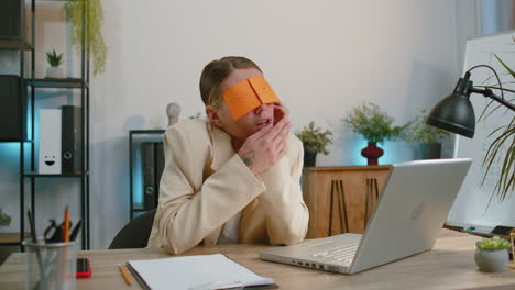 inefficient tired lazy businesswoman working sleeping on laptop computer with eyes stickers on face