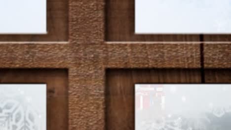 animation of christmas tree, presents and snow falling seen through window