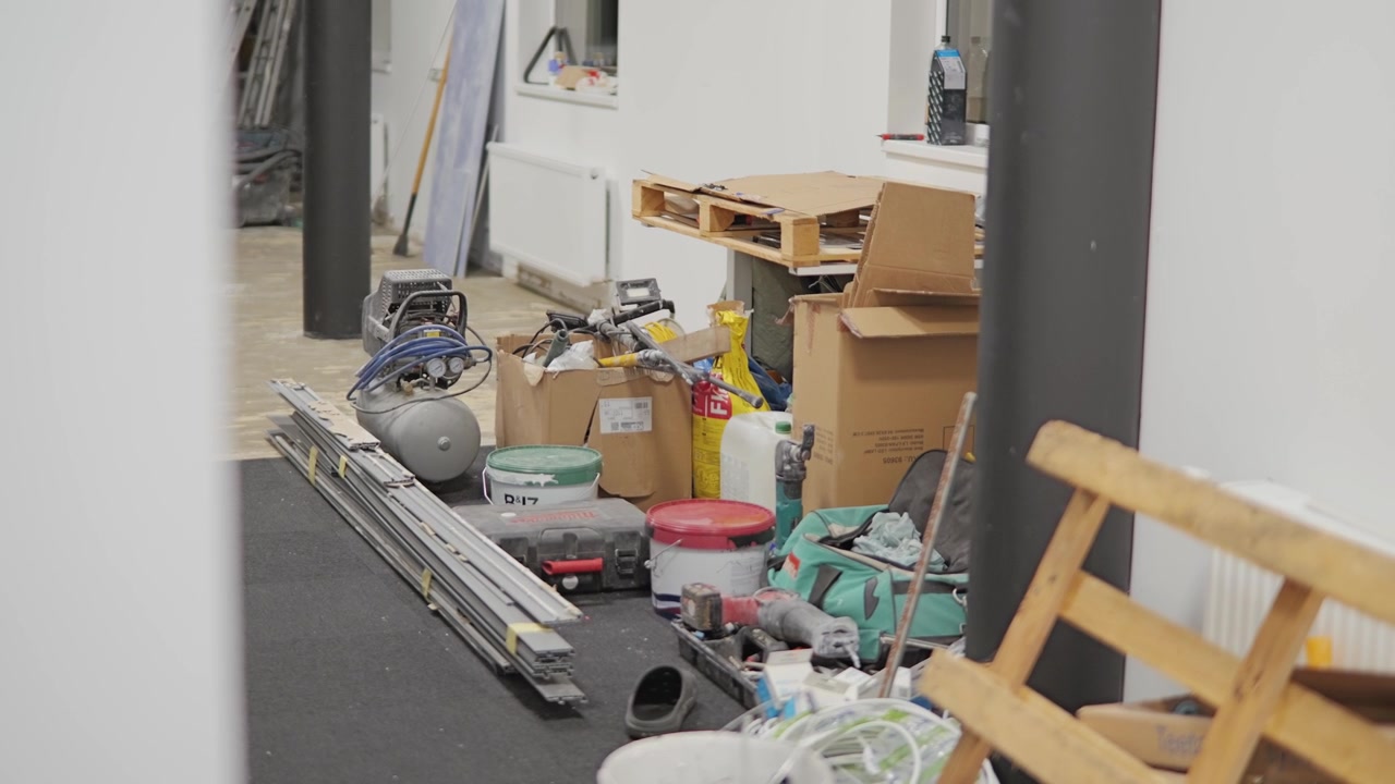 Construction workspace filled with tools, materials and renovation supplies