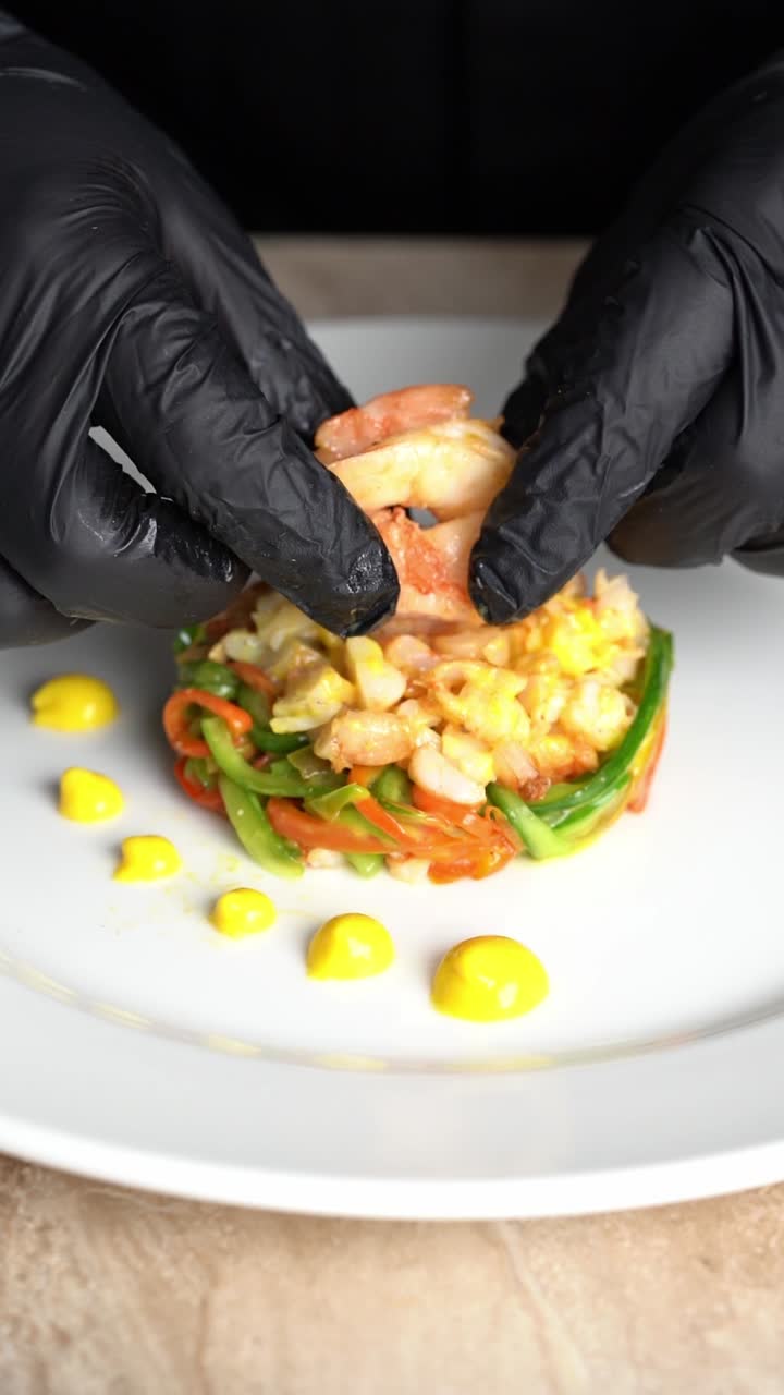 Close-up of Chef Plating a Colorful Shrimp and Vegetable Appetizer
