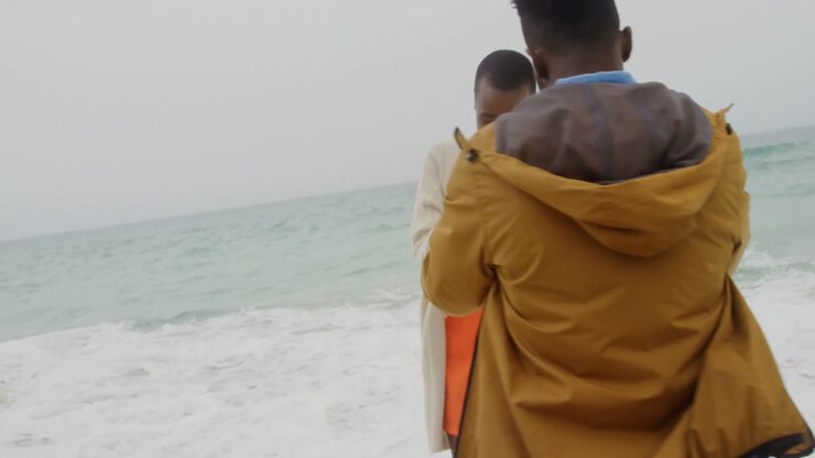 African american couple having fun together on the beach 4k