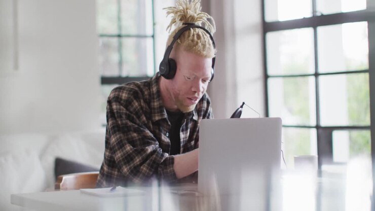Happy albino african american man with dreadlocks making podcast
