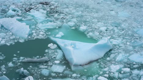 Iceberg-and-Collapsed-Pieces-of-Ice-Floating-in-Ocean-Water,-Close-Up